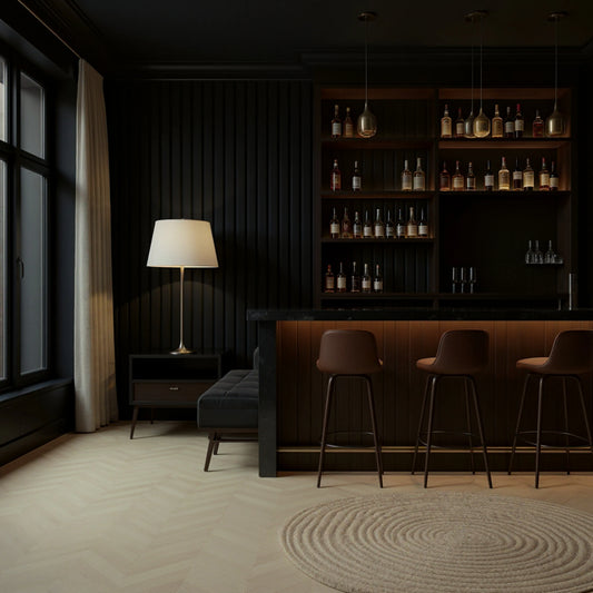 Modern bar interior with dark wood shelves, bar stools, and a lamp.