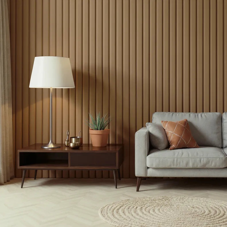Modern minimalist living room with mid-century furniture, featuring a light gray sofa, brown accent pillow, wooden slat wall, floor lamp, indoor plant, and circular beige rug on herringbone flooring.